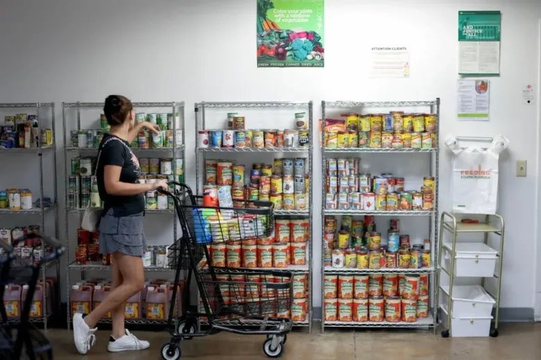 1.1 Million College Students A woman shops at the Feeding South Florida food pantry in Pembroke Park Florida